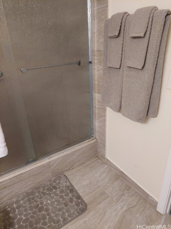 bathroom featuring a shower with door