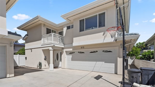 view of front of property featuring a garage and a balcony