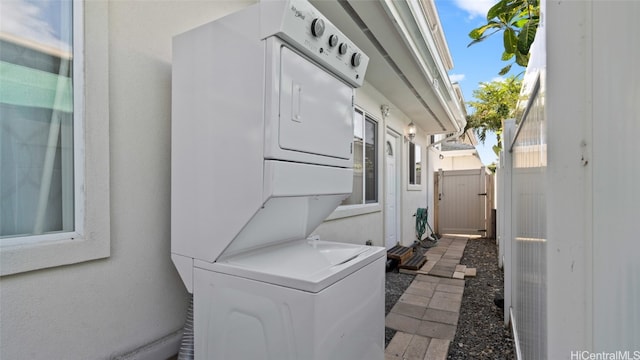 laundry area with stacked washing maching and dryer