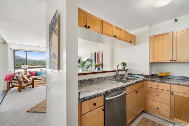 kitchen with stainless steel dishwasher, sink, a textured ceiling, and light colored carpet