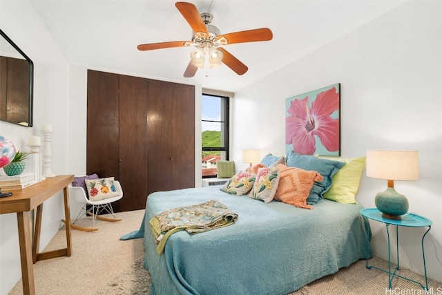 carpeted bedroom featuring a closet and ceiling fan