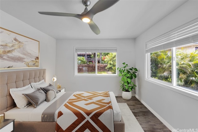 bedroom with dark hardwood / wood-style flooring and ceiling fan