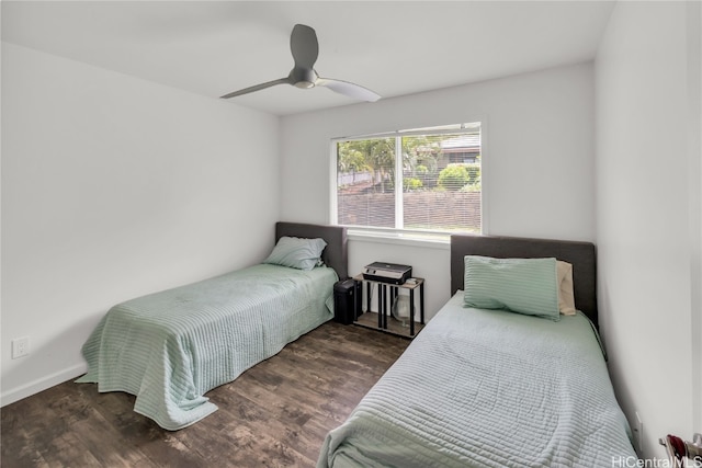 bedroom with dark wood-type flooring and ceiling fan