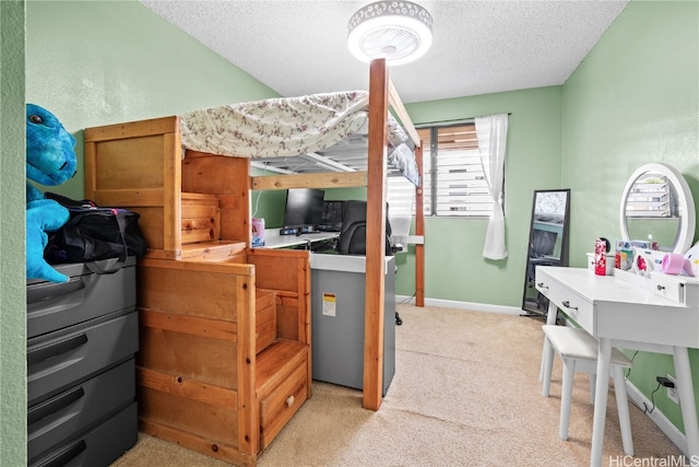 bedroom with light carpet and a textured ceiling