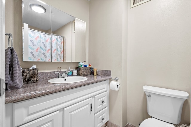 bathroom featuring toilet and vanity