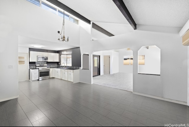 interior space with a wealth of natural light, sink, white cabinets, and stainless steel appliances