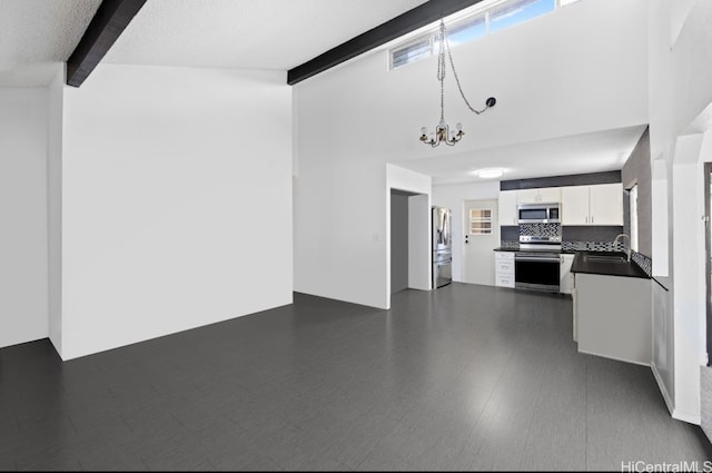 kitchen featuring dark hardwood / wood-style floors, beamed ceiling, stainless steel appliances, a notable chandelier, and white cabinetry