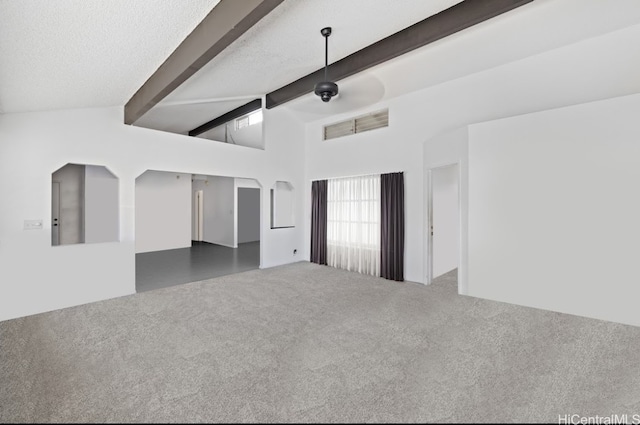 spare room featuring beamed ceiling, dark colored carpet, a textured ceiling, and high vaulted ceiling