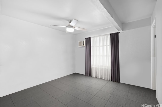 empty room featuring ceiling fan and beamed ceiling