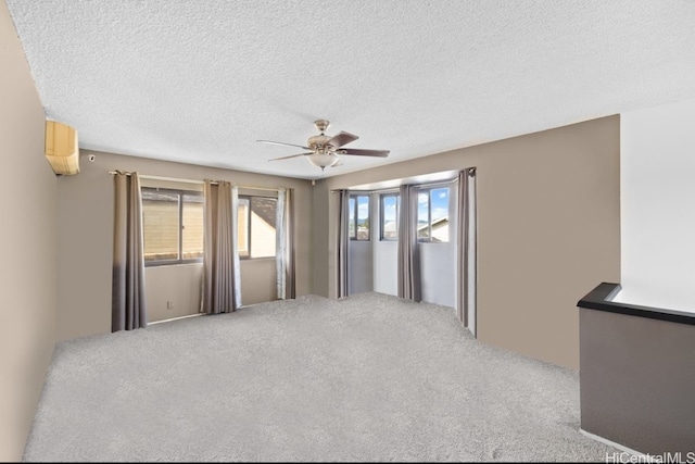 carpeted empty room featuring a textured ceiling and ceiling fan