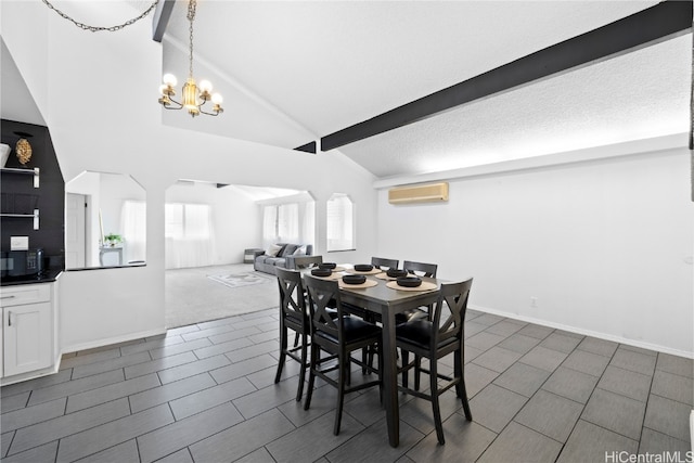 dining space featuring vaulted ceiling with beams, a wall unit AC, a notable chandelier, and dark carpet