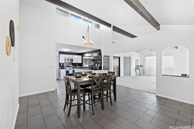 carpeted dining room with high vaulted ceiling, a healthy amount of sunlight, a textured ceiling, and beam ceiling