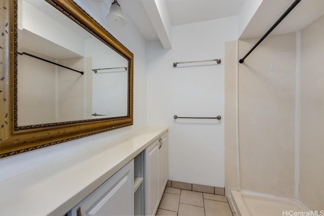 bathroom featuring vanity, a shower, and tile patterned flooring