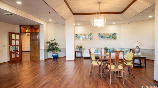 dining area featuring crown molding, french doors, a chandelier, and dark wood-type flooring