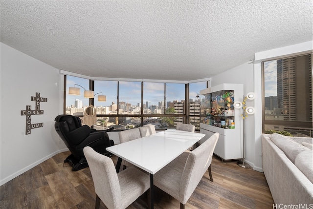 dining area with a textured ceiling, floor to ceiling windows, and dark hardwood / wood-style flooring