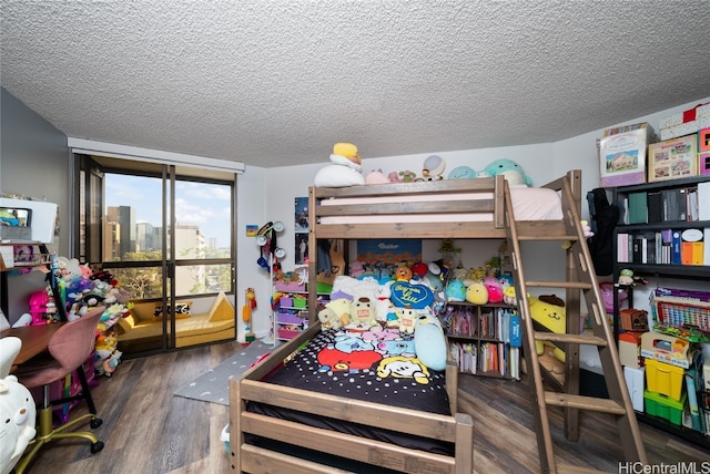 bedroom featuring a textured ceiling and dark hardwood / wood-style flooring