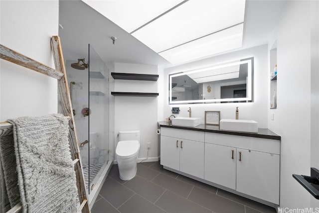 bathroom featuring toilet, an enclosed shower, vanity, and tile patterned floors