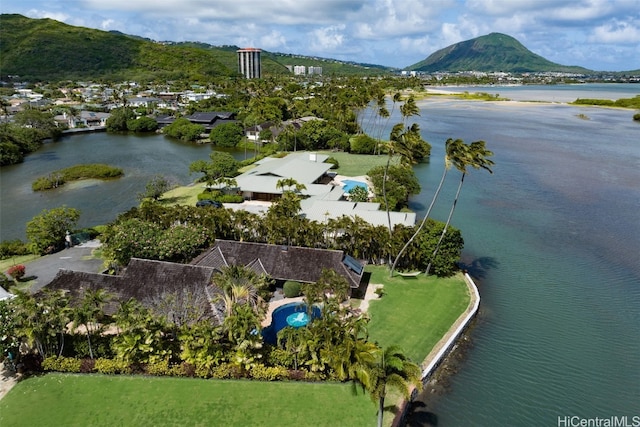 birds eye view of property with a water and mountain view