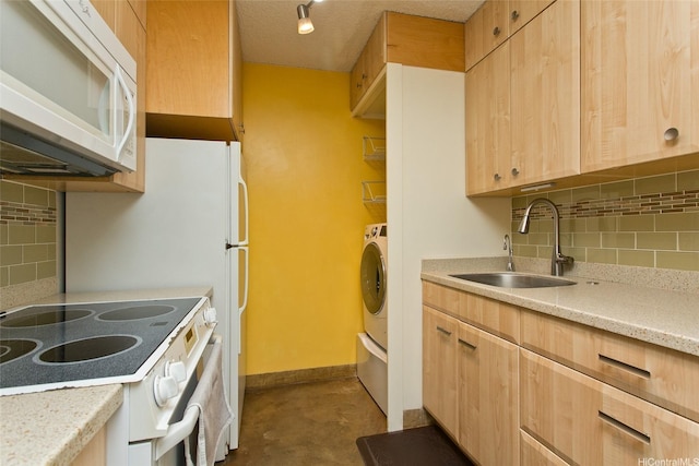 kitchen with light brown cabinetry, white appliances, a sink, and decorative backsplash