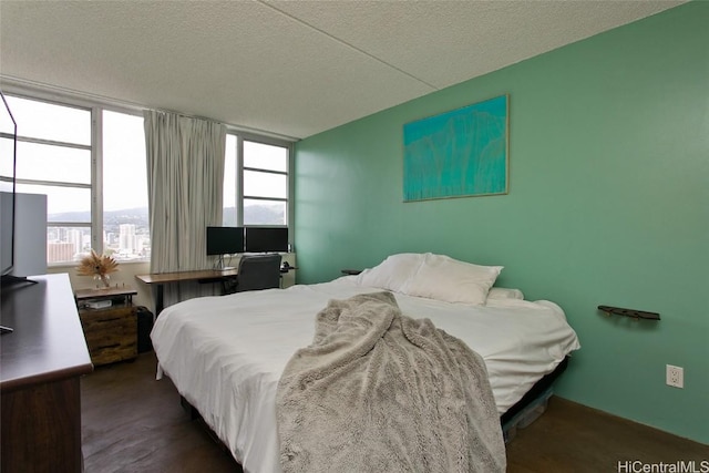 bedroom with multiple windows and a textured ceiling