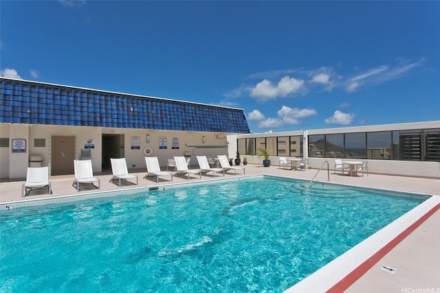 community pool with a patio area