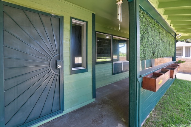 view of exterior entry with covered porch