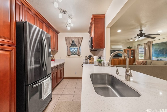 kitchen featuring track lighting, light tile patterned floors, ceiling fan, sink, and stainless steel appliances