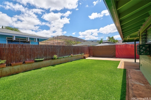 view of yard with a patio and a mountain view