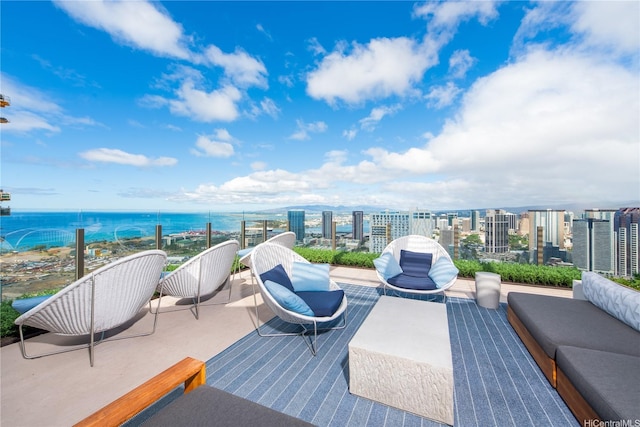 view of patio / terrace featuring a view of city, outdoor lounge area, and a water view