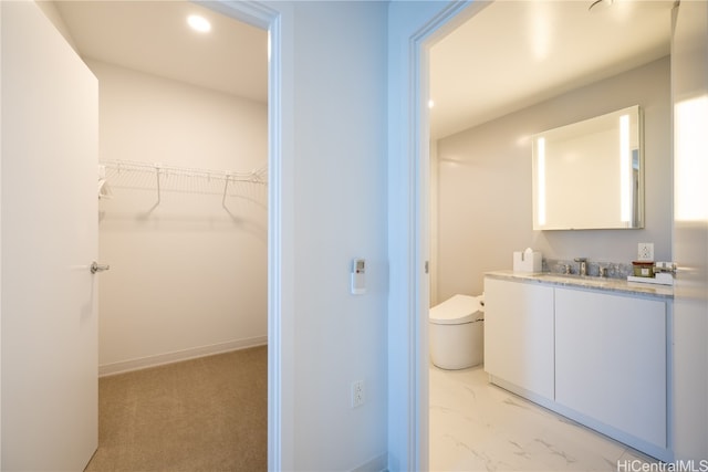 bathroom featuring vanity and toilet