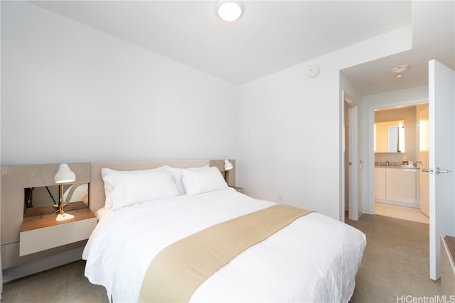 carpeted bedroom featuring ensuite bathroom