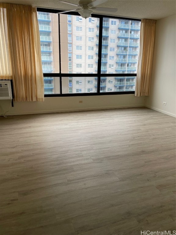 unfurnished room with hardwood / wood-style floors and ceiling fan