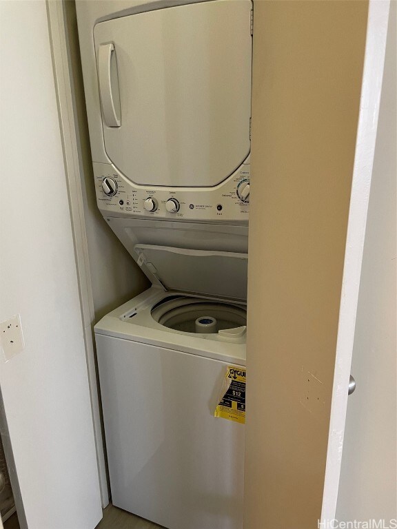 laundry area with stacked washer and clothes dryer