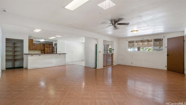 unfurnished living room featuring ceiling fan and light parquet flooring