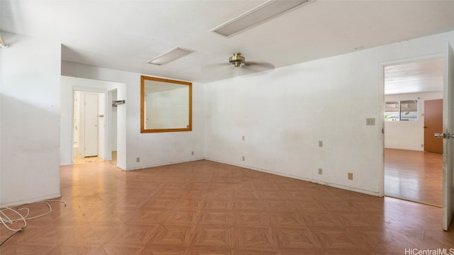 spare room with ceiling fan and parquet floors