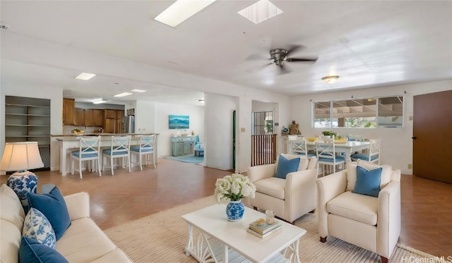 living room featuring light parquet flooring and ceiling fan