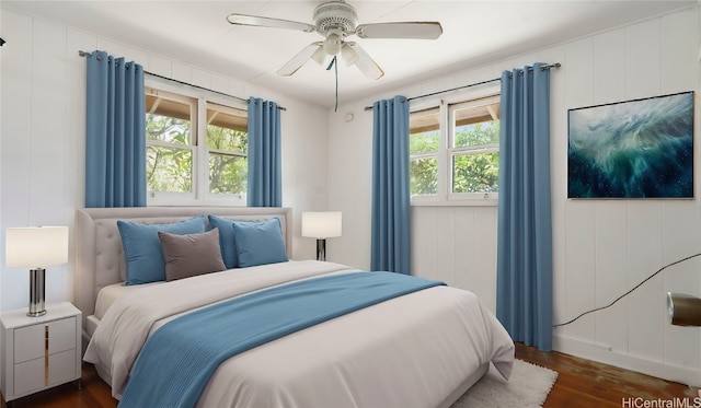 bedroom with ceiling fan and dark hardwood / wood-style floors