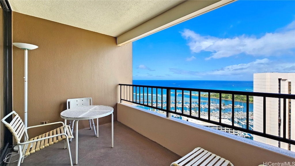 balcony featuring a water view and a view of the beach