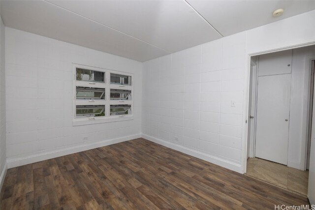 spare room featuring dark hardwood / wood-style flooring