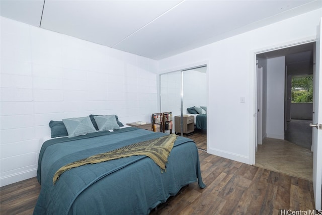 bedroom with a closet and dark wood-type flooring