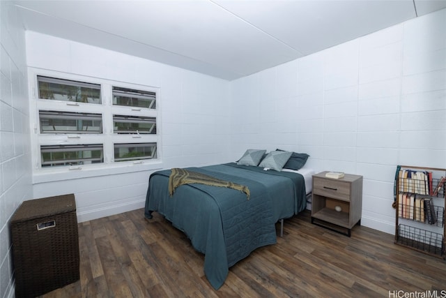 bedroom with dark hardwood / wood-style flooring