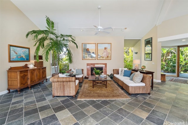 living room with lofted ceiling, track lighting, and ceiling fan