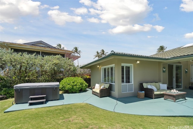 back of property featuring a patio, a hot tub, a lawn, and an outdoor hangout area