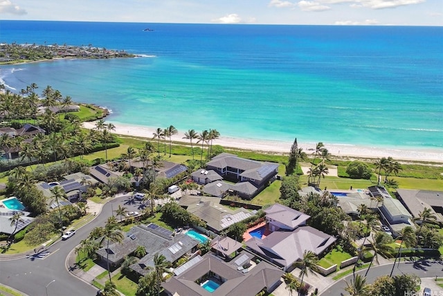 drone / aerial view with a residential view, a view of the beach, and a water view