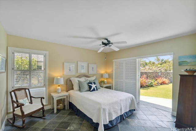 bedroom featuring ceiling fan, multiple windows, and access to exterior