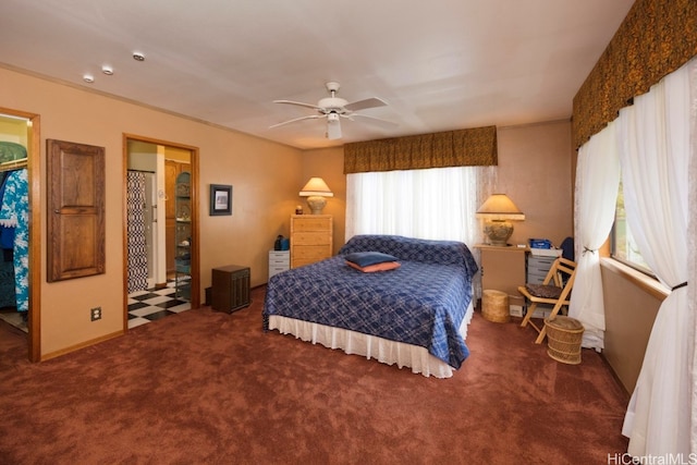 bedroom with dark colored carpet and ceiling fan