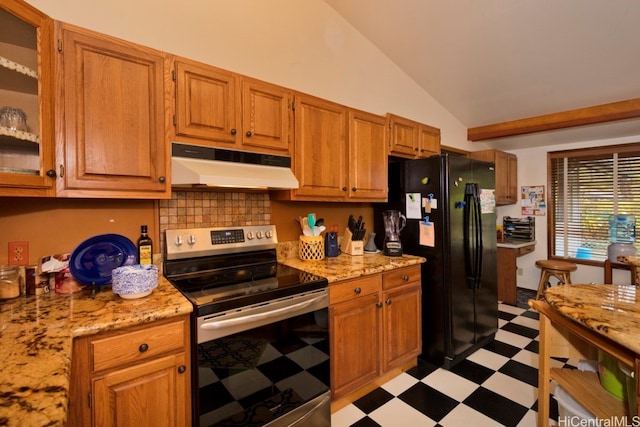 kitchen featuring stainless steel range with electric stovetop, light stone countertops, lofted ceiling, and black refrigerator