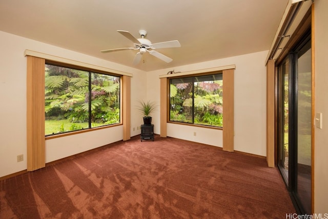 carpeted empty room featuring ceiling fan