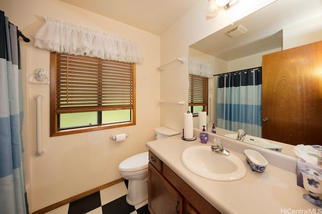 bathroom with vanity, walk in shower, and toilet