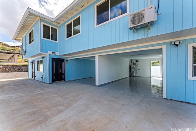 back of property featuring a carport and ac unit